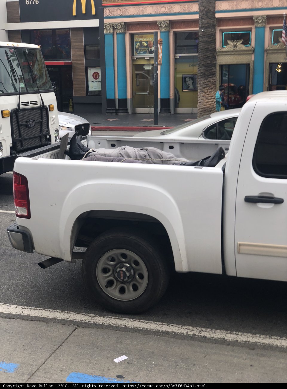 White Pickup Truck in Front of Storefront