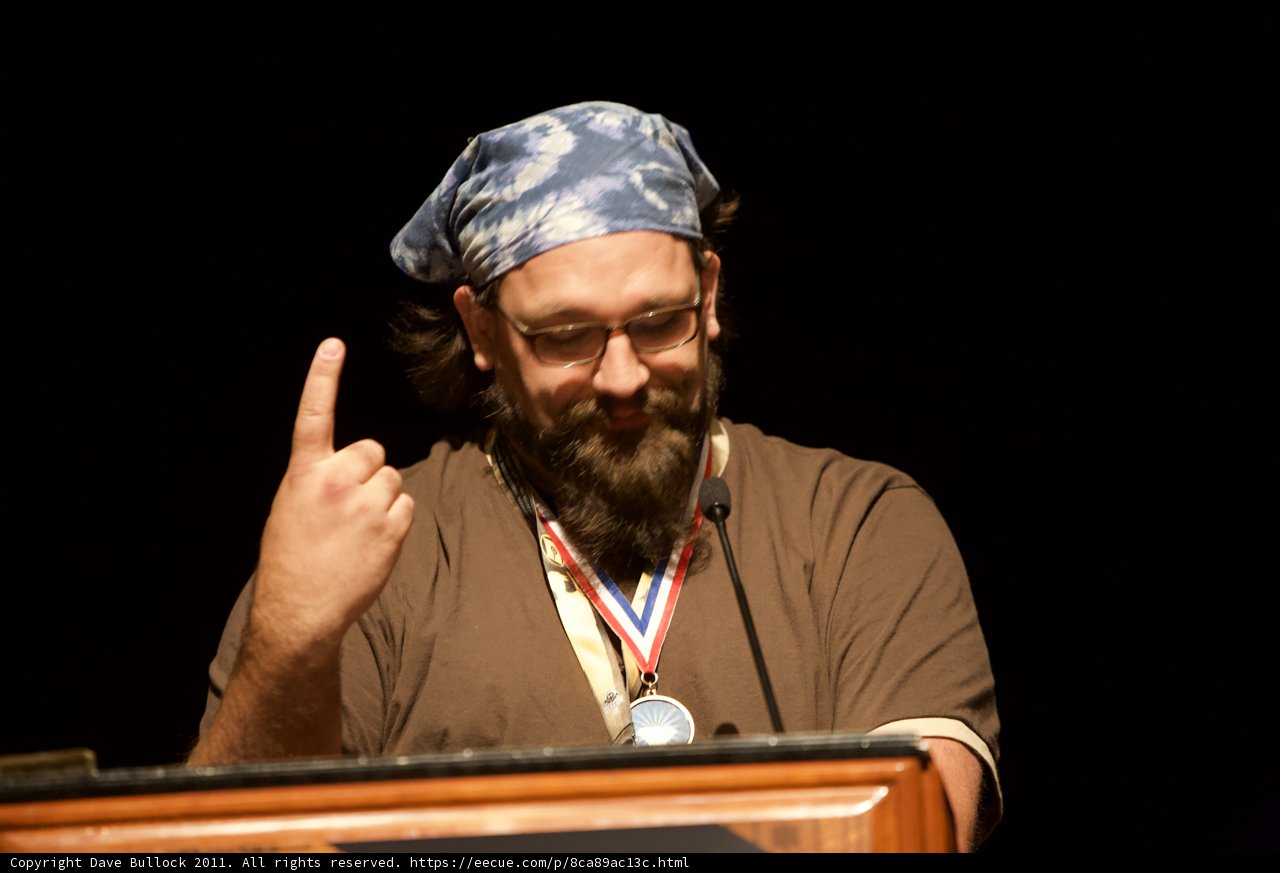 Medal-Winning Bearded Man on Podium