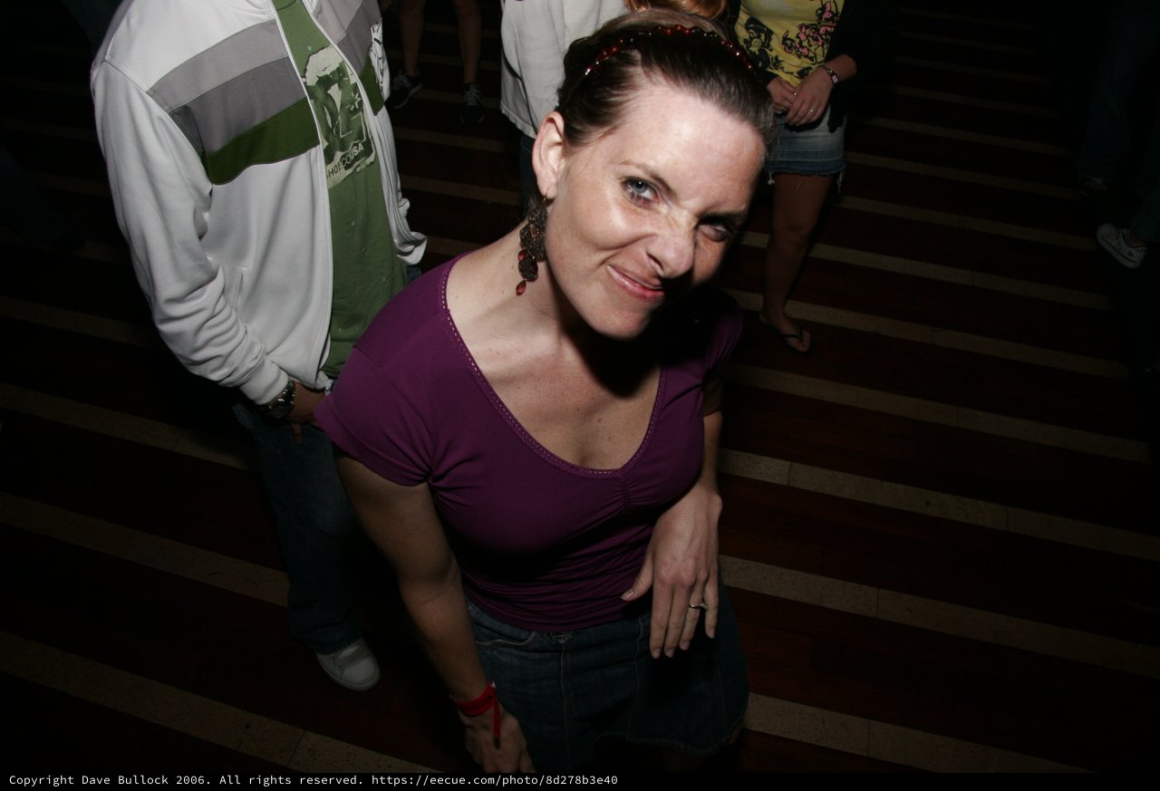 Woman Smiling at Camera During Nighttime Event