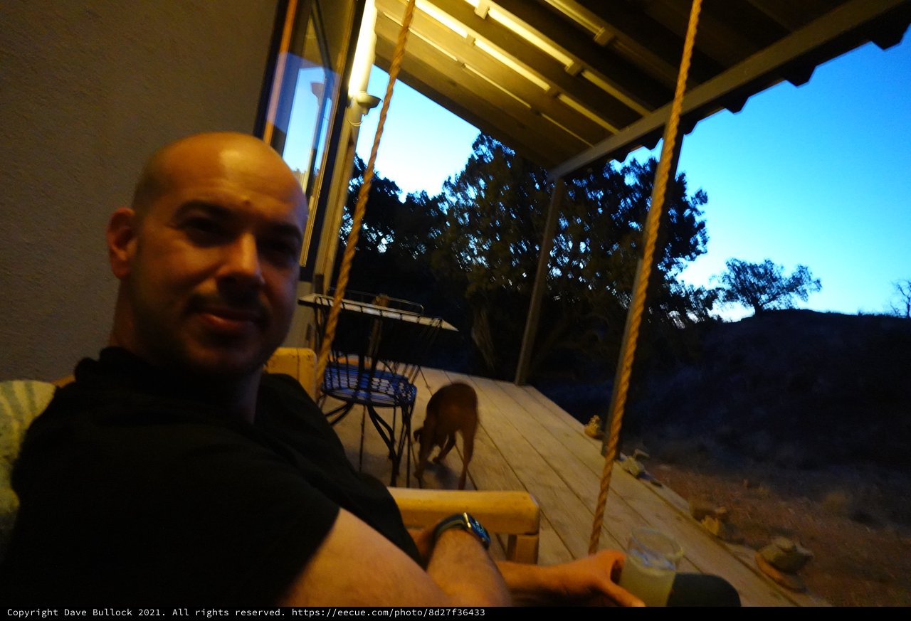 Bald Man Enjoying Evening on Covered Porch