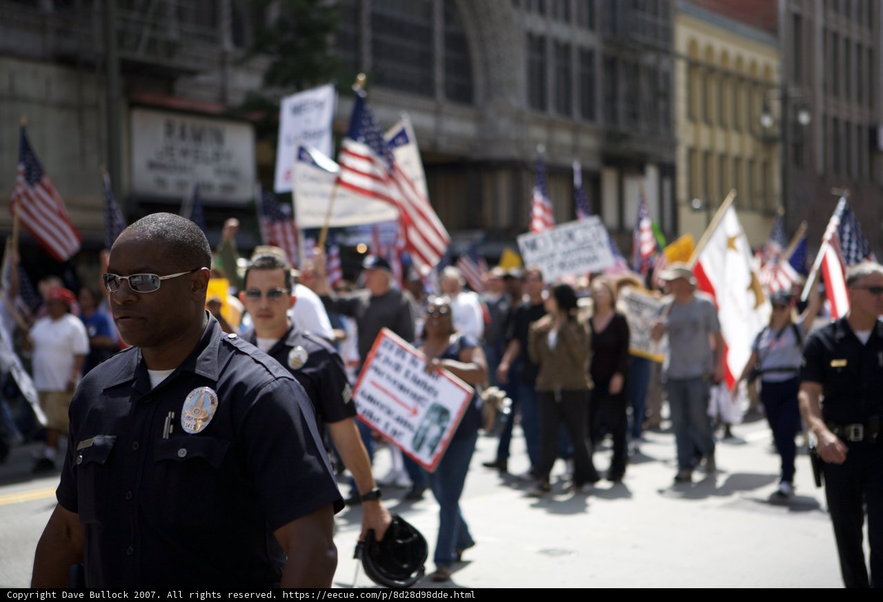 Police Officer Joins Protestors at Black Minutemen Parade