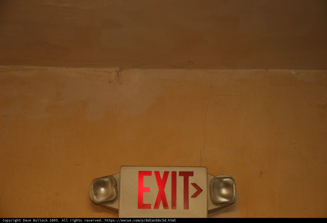 Red Exit Sign on Wood Wall