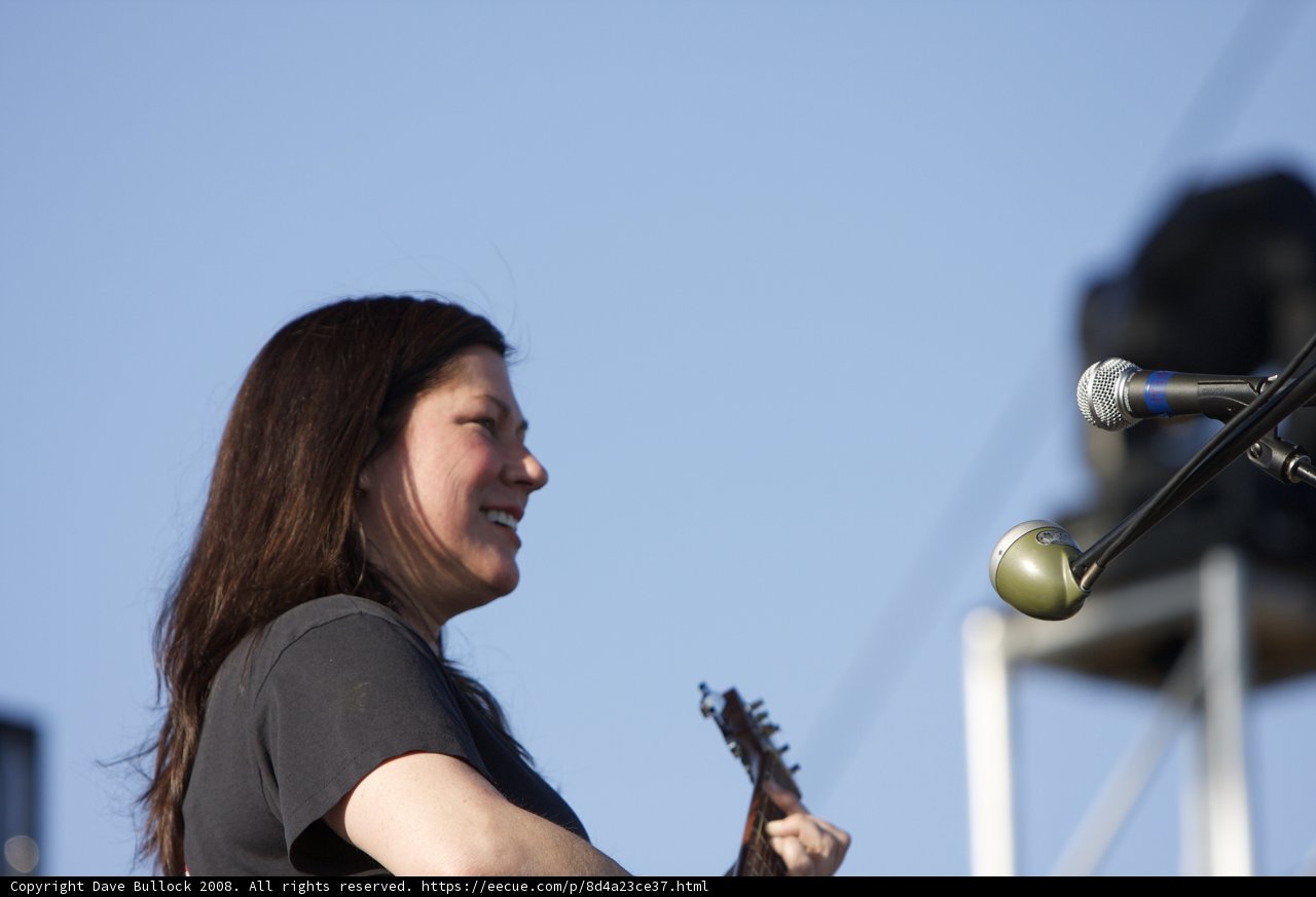 Kim Deal strums her guitar under the blue sky