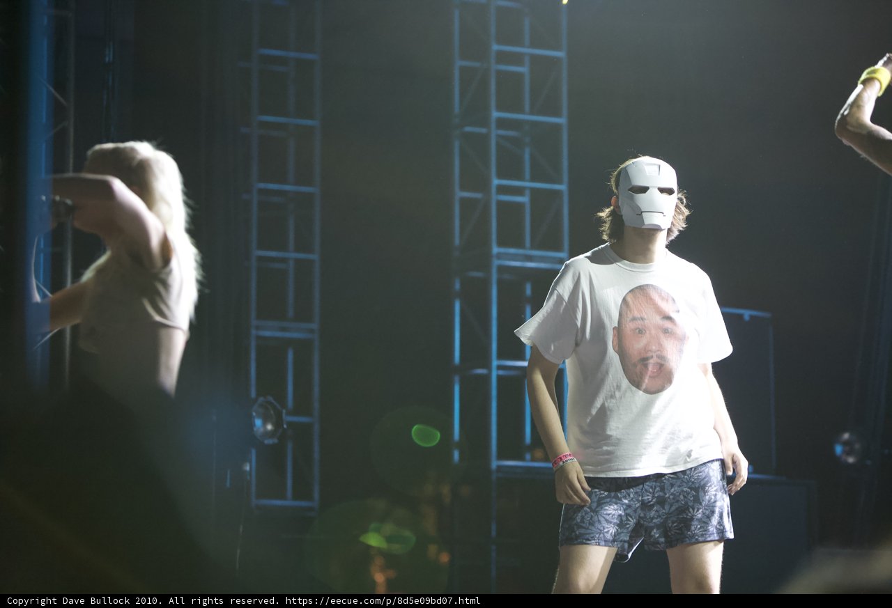 Masked Man on Stage with a Crowd
