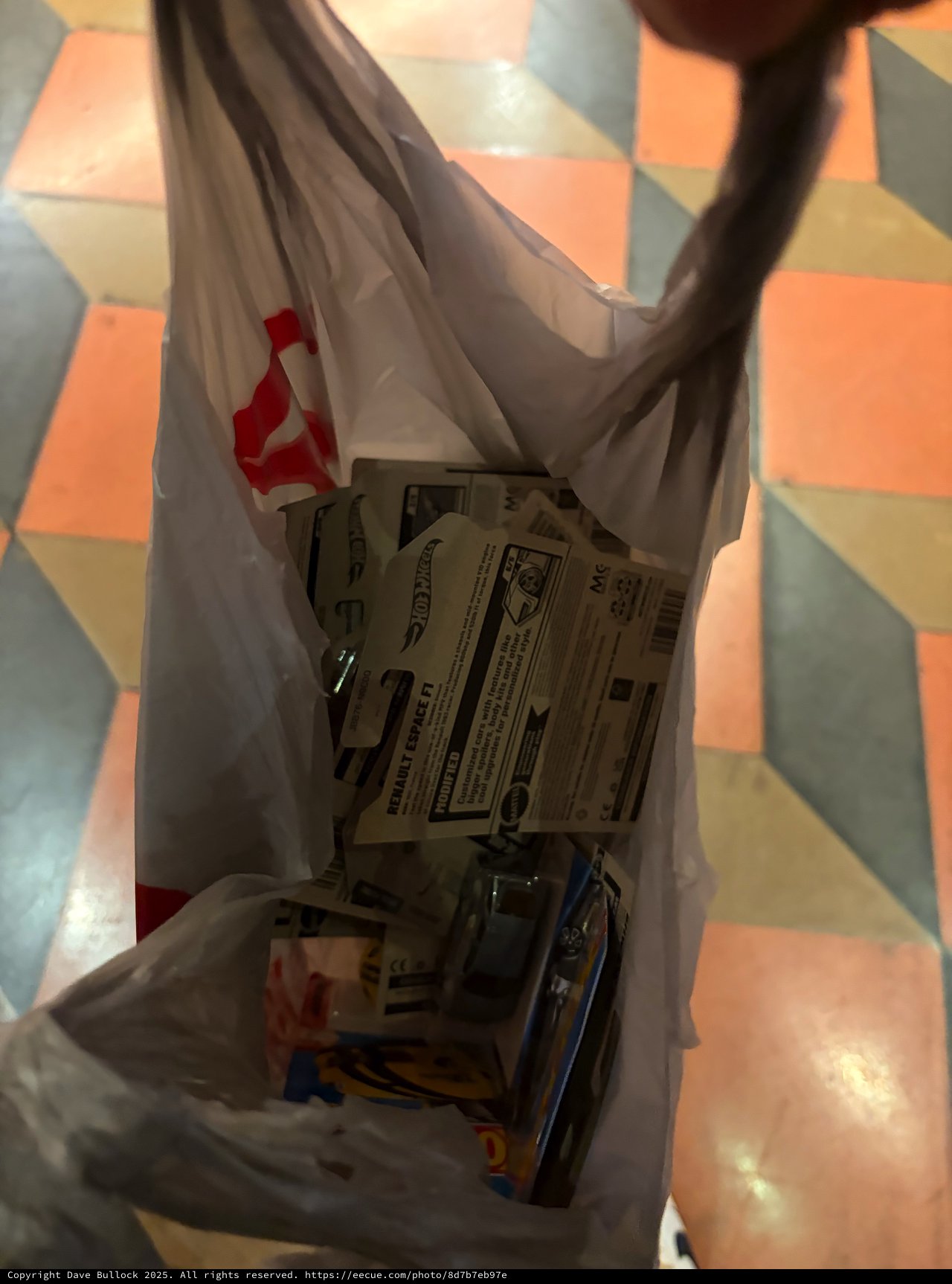 Plastic Shopping Bag with Toy Cars on Colorful Floor