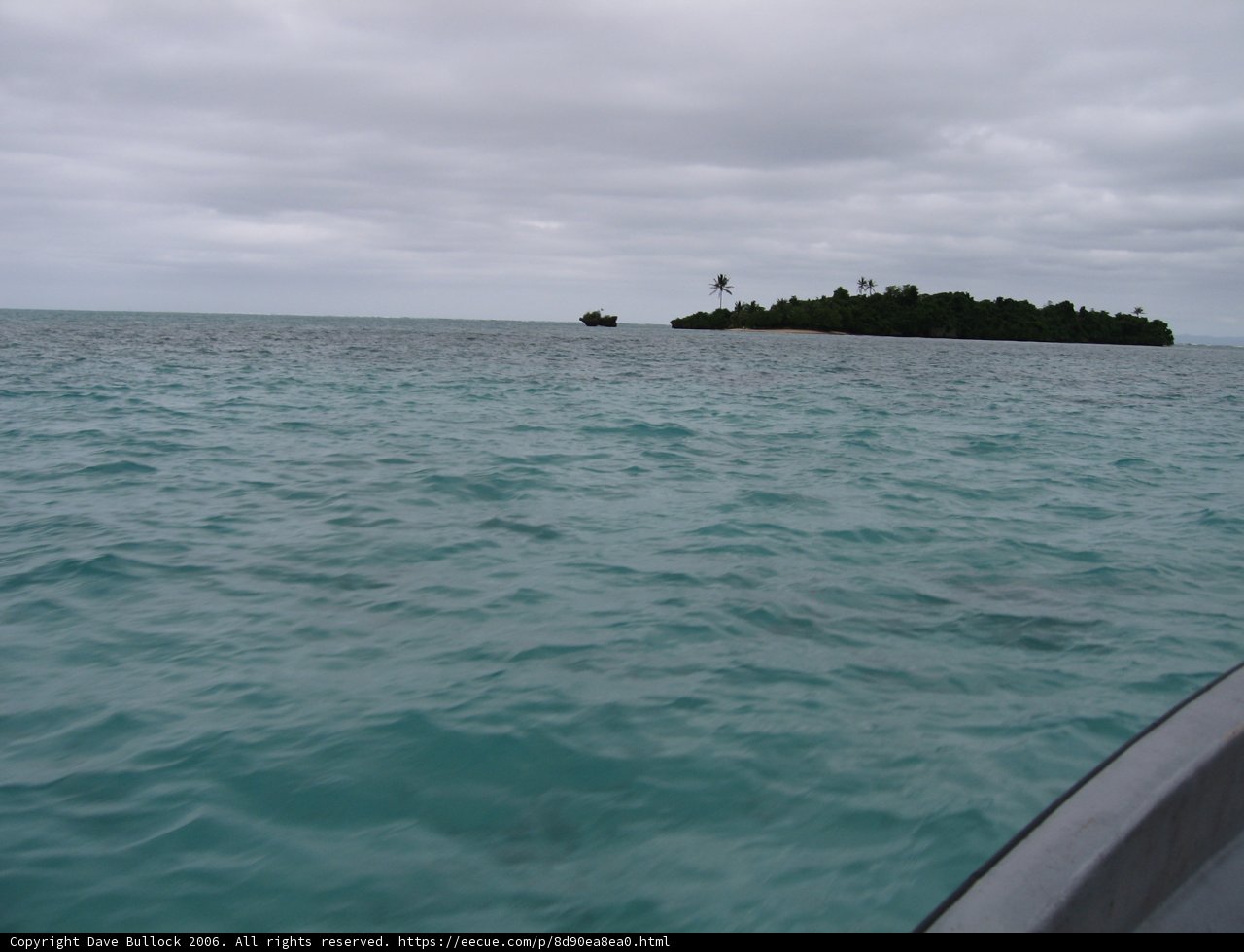 A Boat Anchored Near the Island