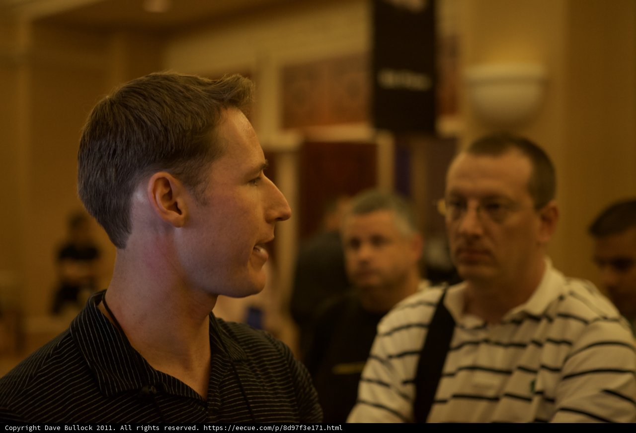 Two Men Having a Discussion in a Crowded Room