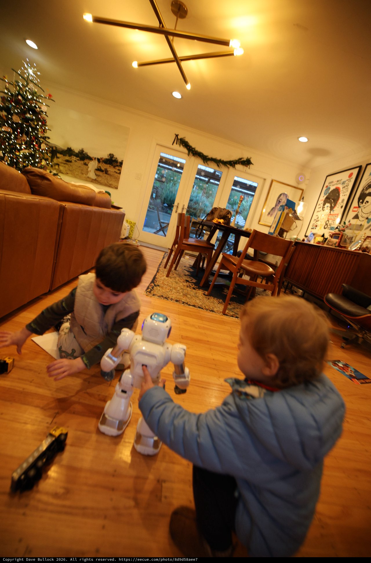 Children Playing with White Robot in Modern Living Room