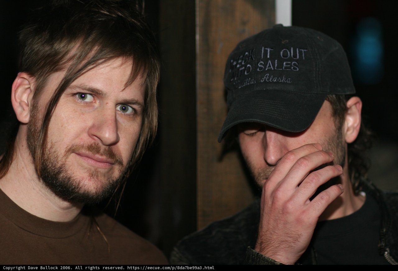Long-Haired Duo in Baseball Caps