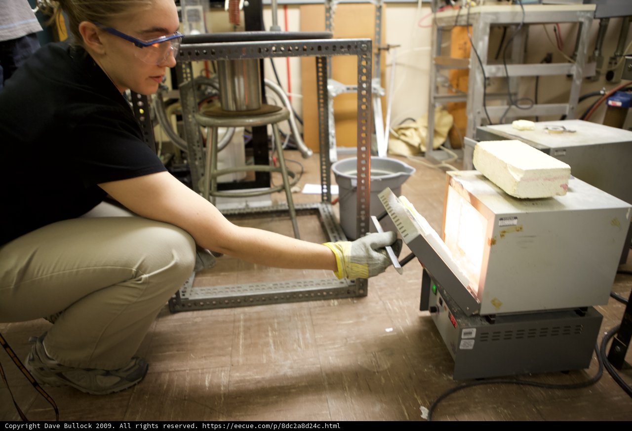 Woman in Black Shirt Working in Factory