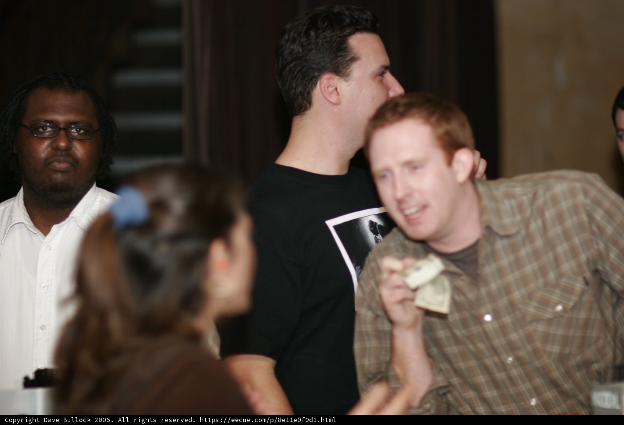 Brown Shirted Man with Two Others