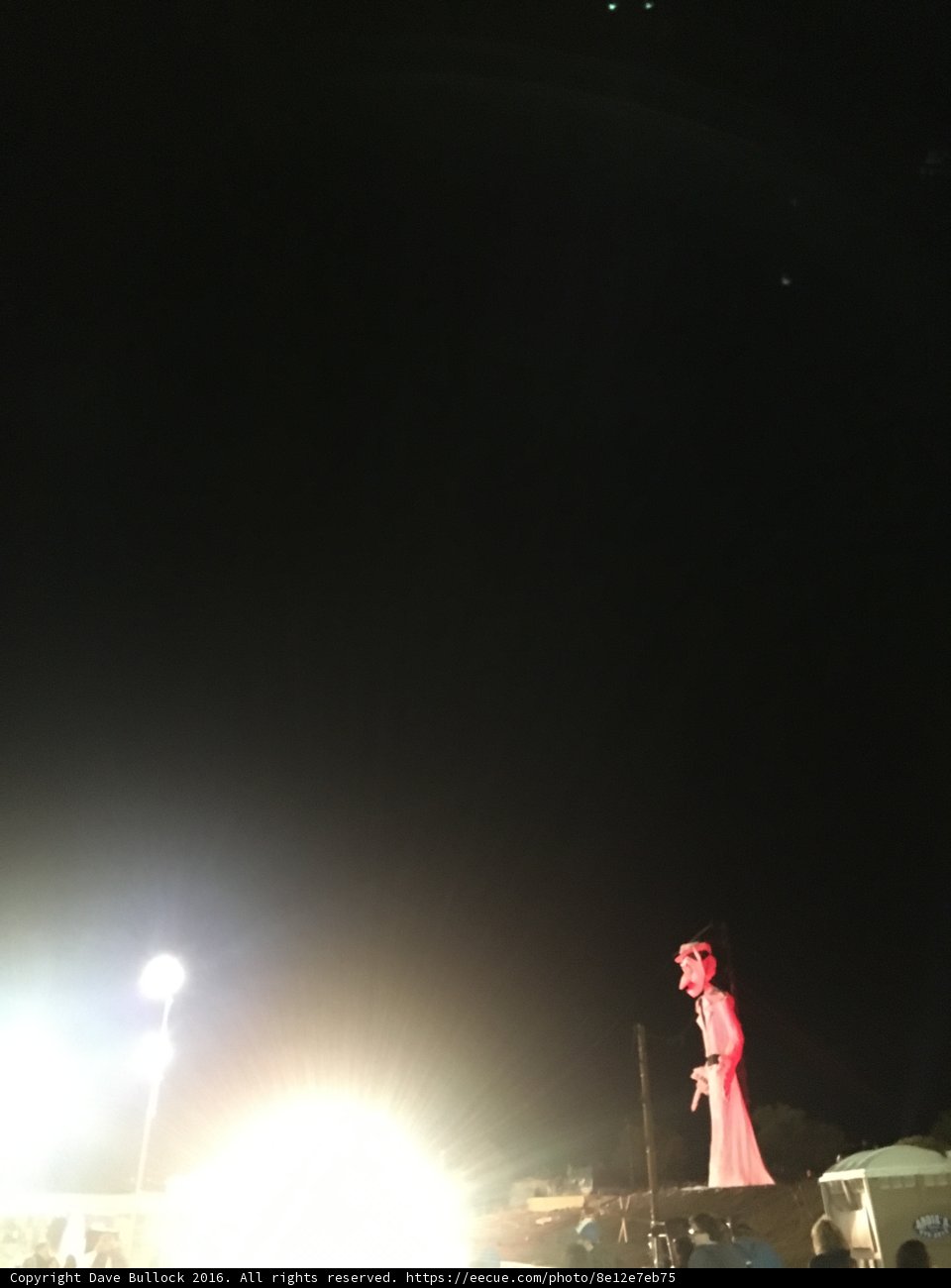 Red Statue Illuminated by Night Sky