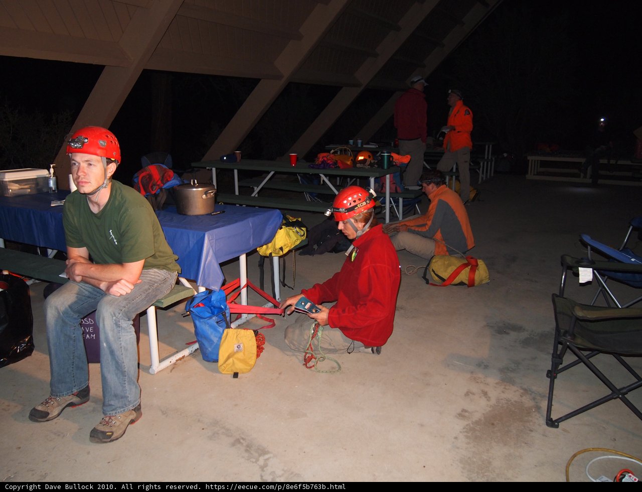 Man in Red Shirt Sitting on Folding Chair