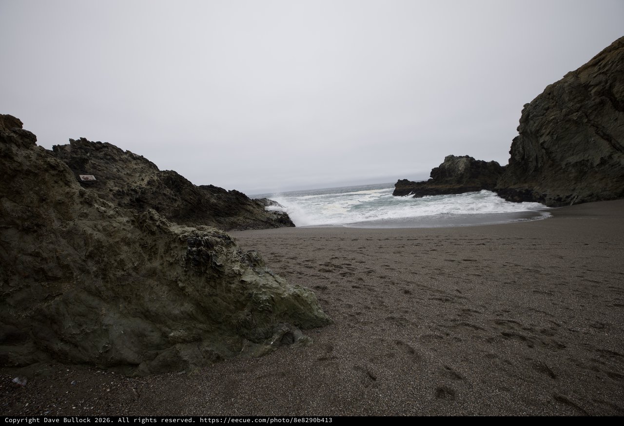 Wild Cove Beach Framed by Dark Sea Cliffs