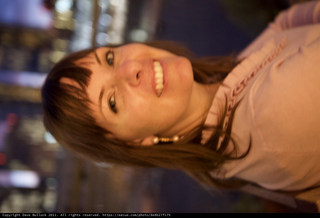 Penelope Smiling Against City Lights at Night