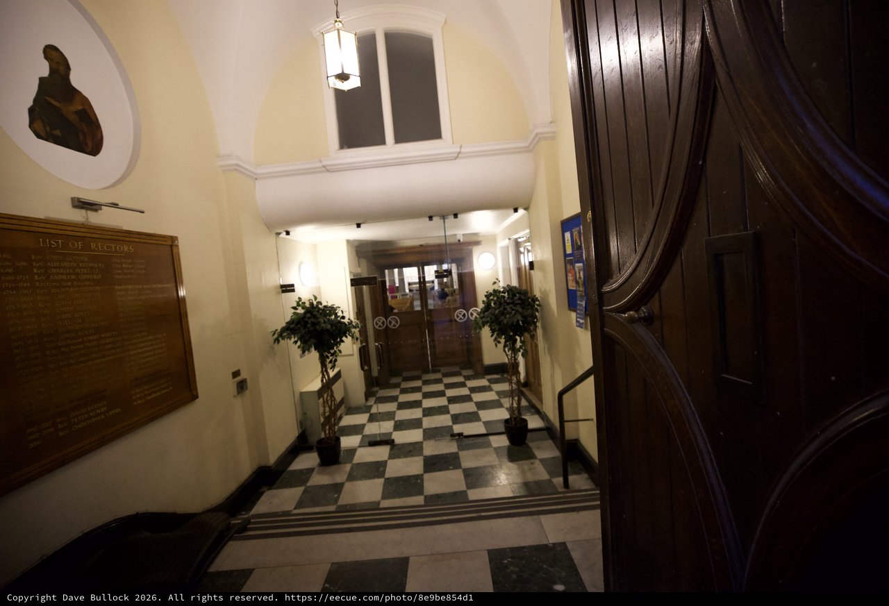 Grand Entrance Hall with Checkered Floor and Wooden Staircase