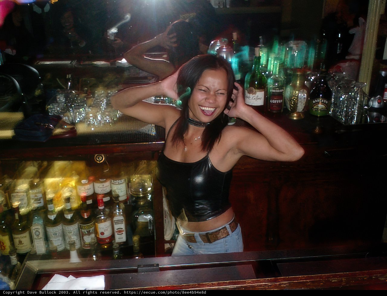 Leather-clad Bartender at an Urban Pub