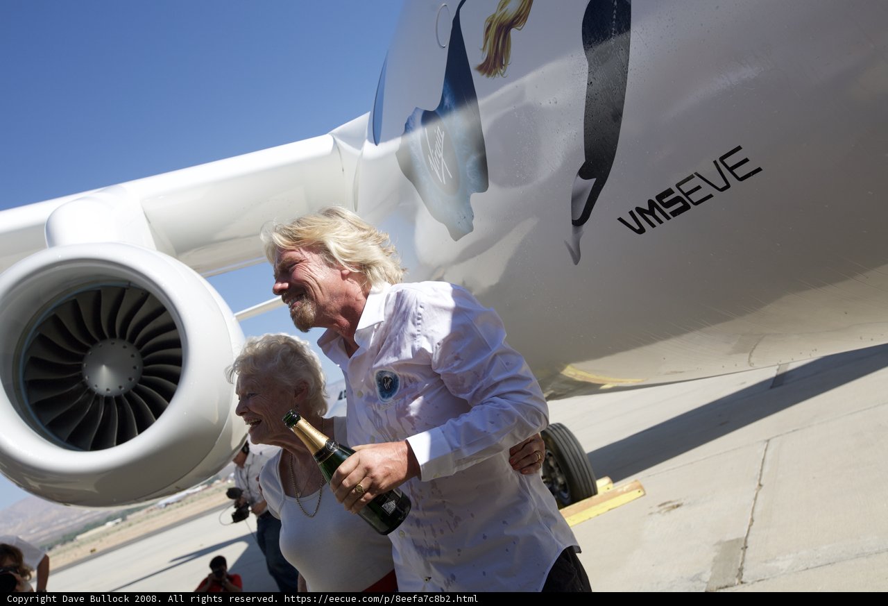 Richard Branson and companions pose next to their aircraft