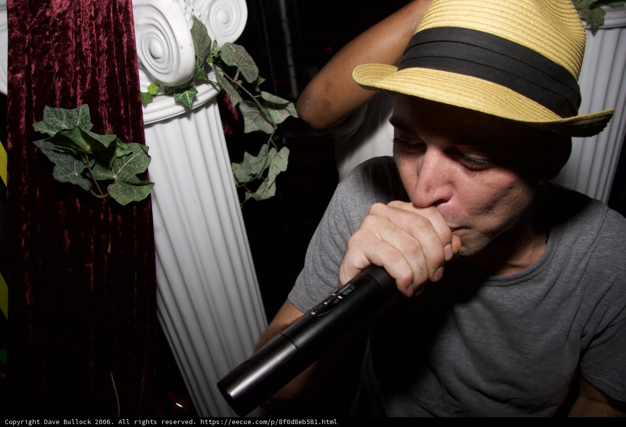 The Man in the Fedora Holding the Mic