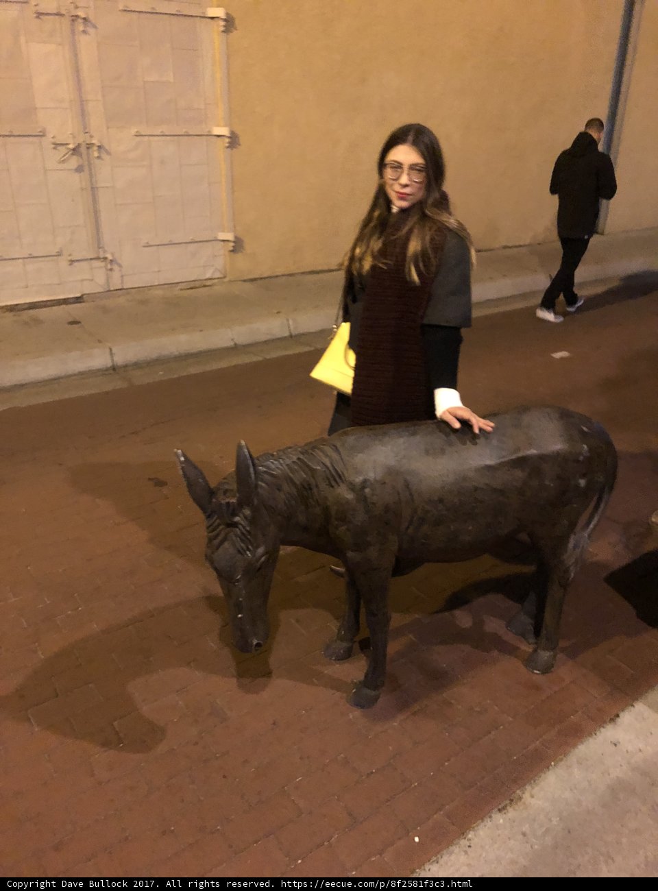 Lori S standing next to statue of a donkey