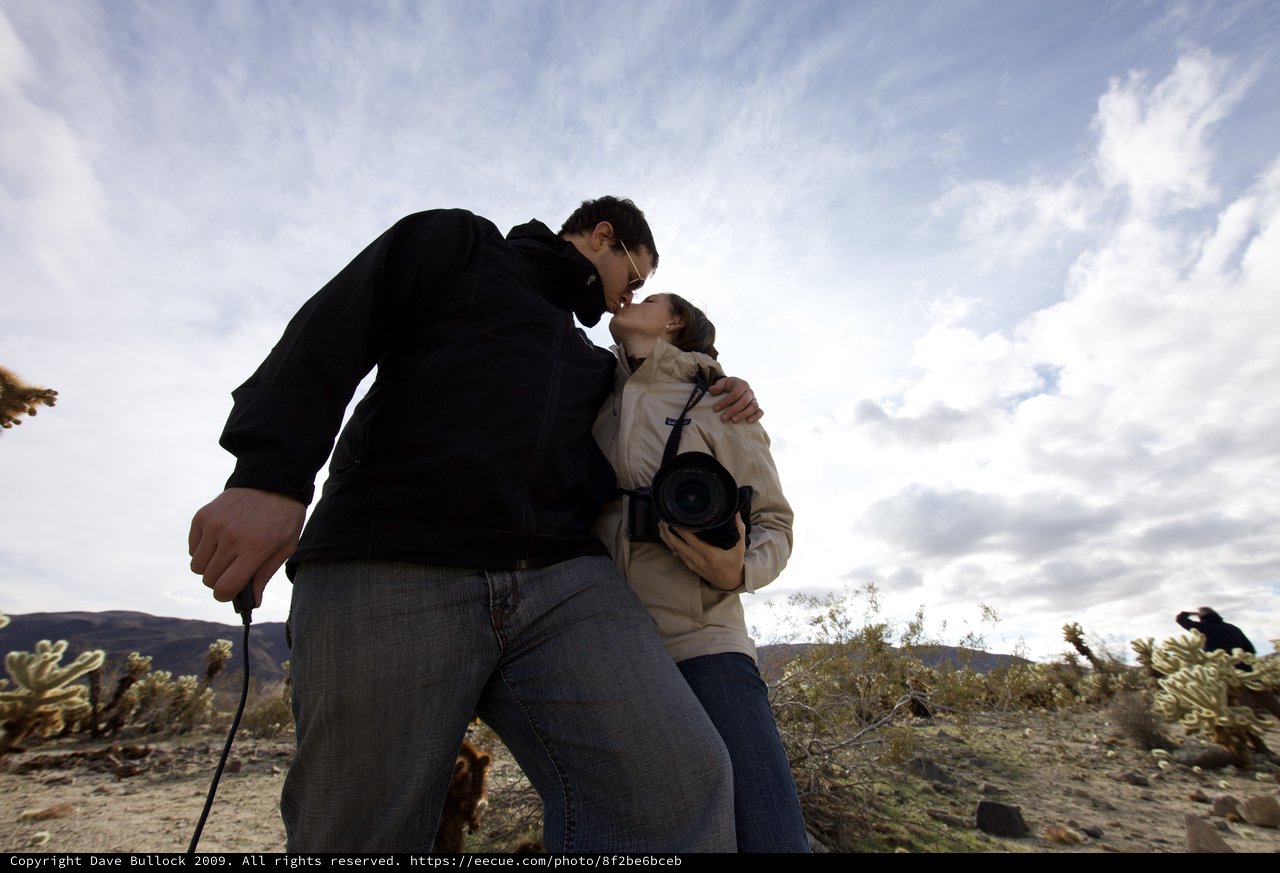 Romantic Desert Kiss Under Dramatic Skies