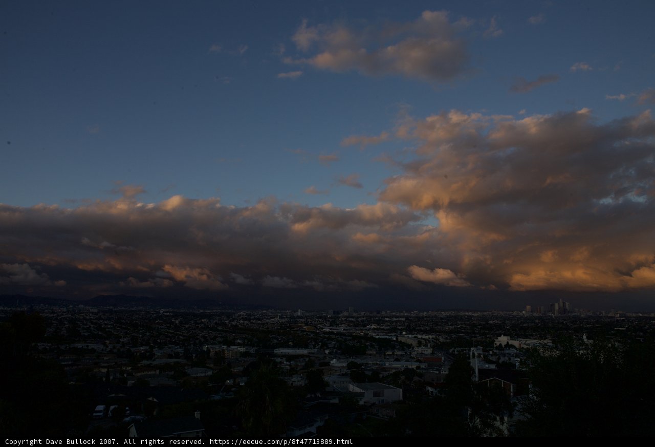 Clouds Roll in Over City at Sunset