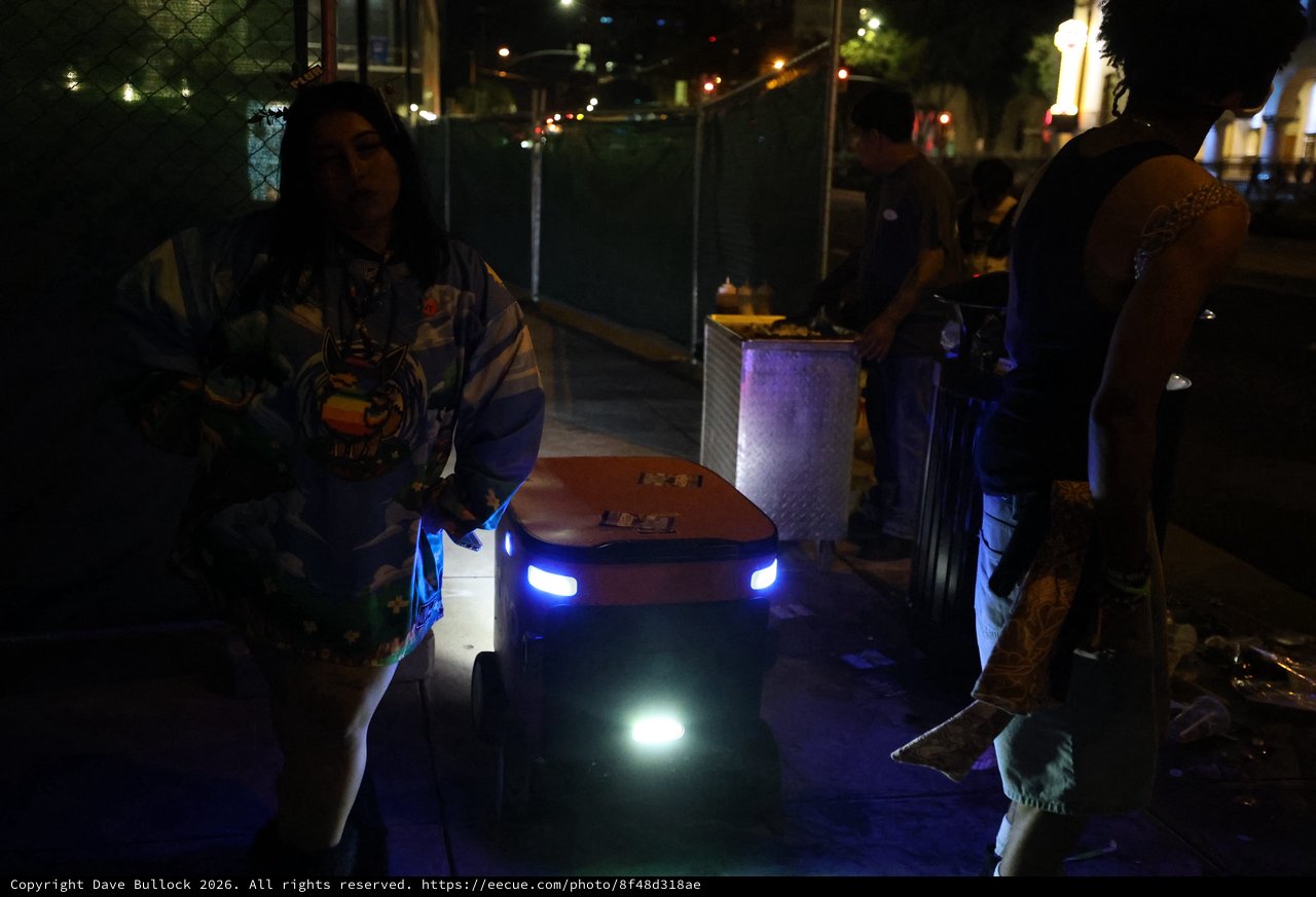 Delivery Robot Navigates Nighttime Festival Crowd