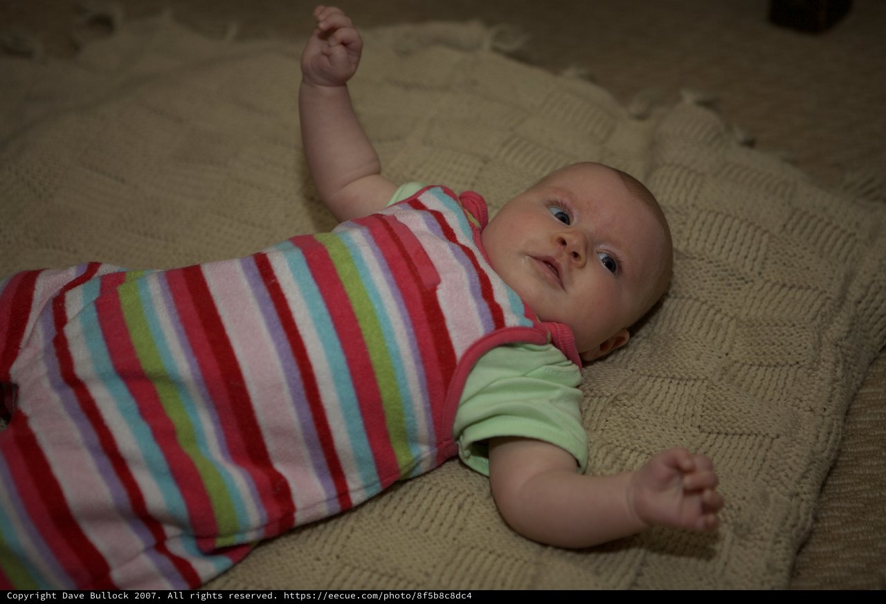 Curious Infant Awake on Knitted Blanket