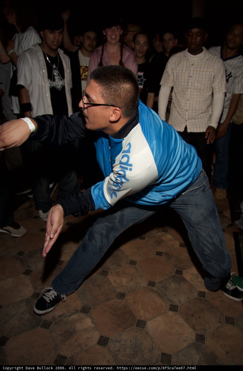 Blue Jacket Moves Caption: Stephen Bishop shows off his dancing skills while his friend Scott Goodman keeps the beat, both sporting stylish blue jackets and sneakers.