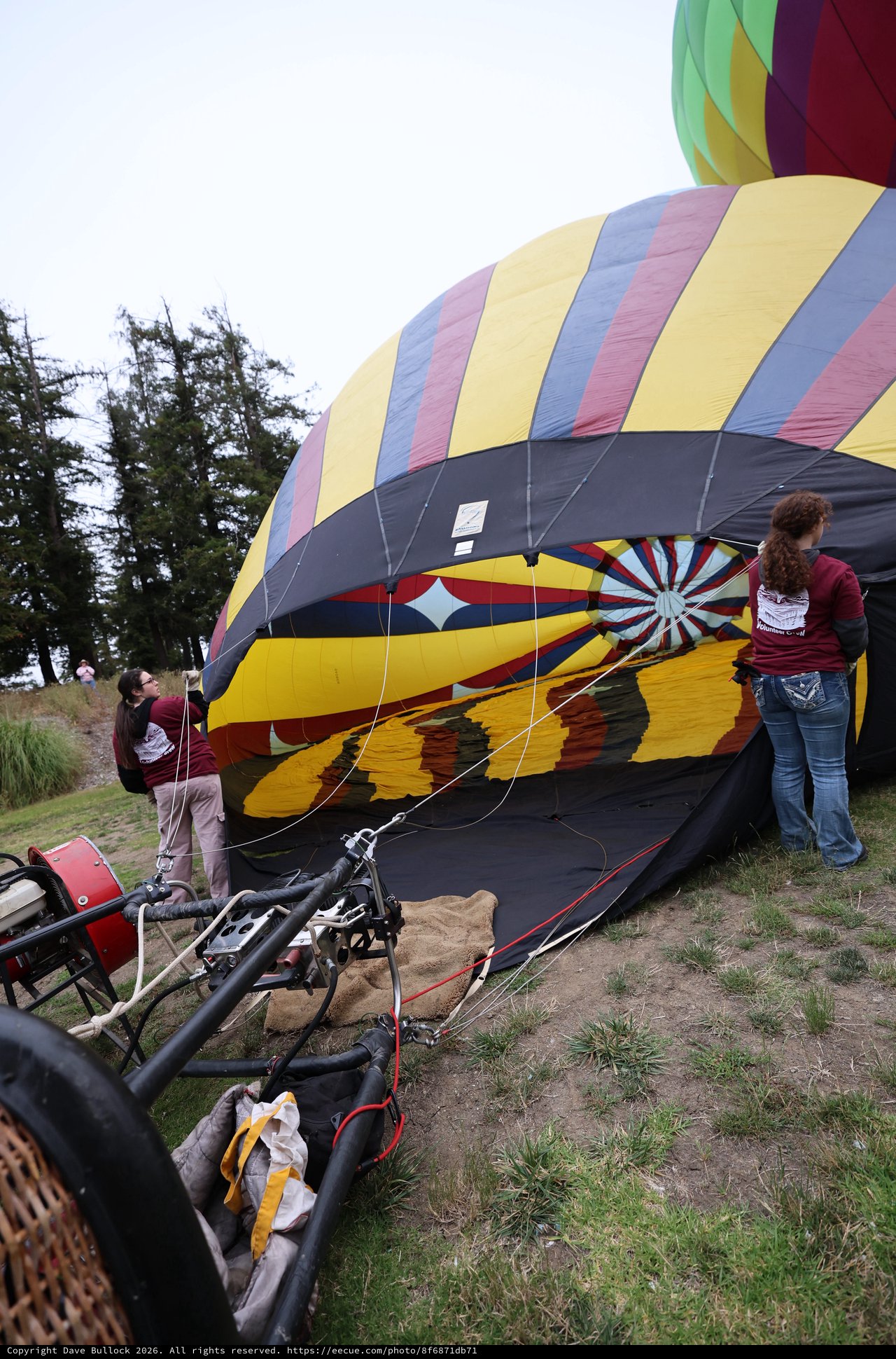 Ground Crew Inflating Colorful Hot Air Balloon at Festival
