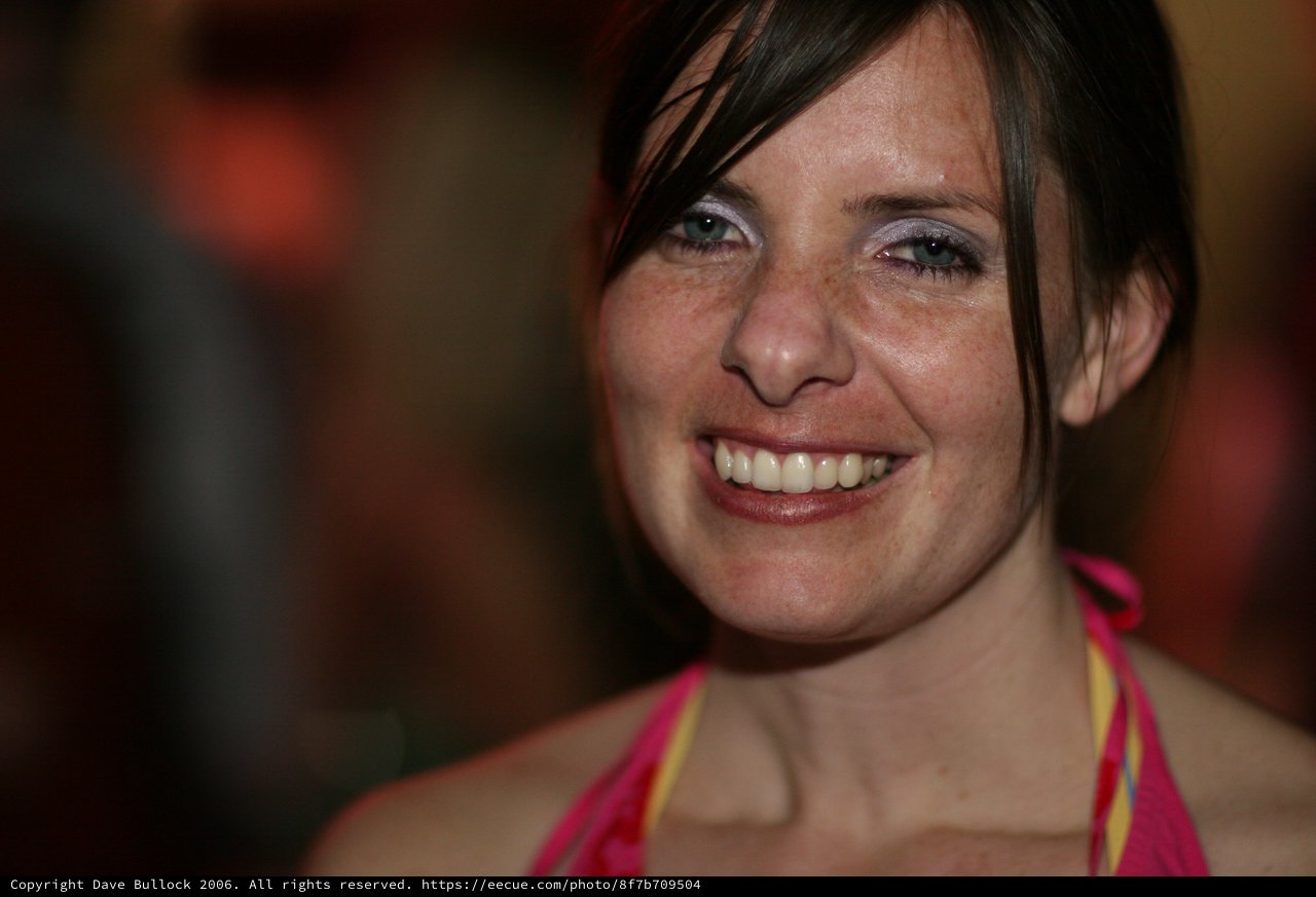 Radiant Smile at a Lively Evening Event