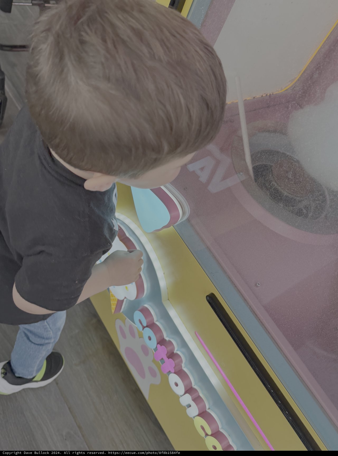 Young Child Explores Interactive Gaming Machine