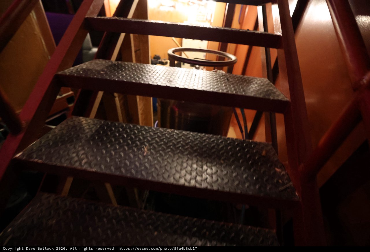 Industrial Steel Staircase Descending Into Dim Basement