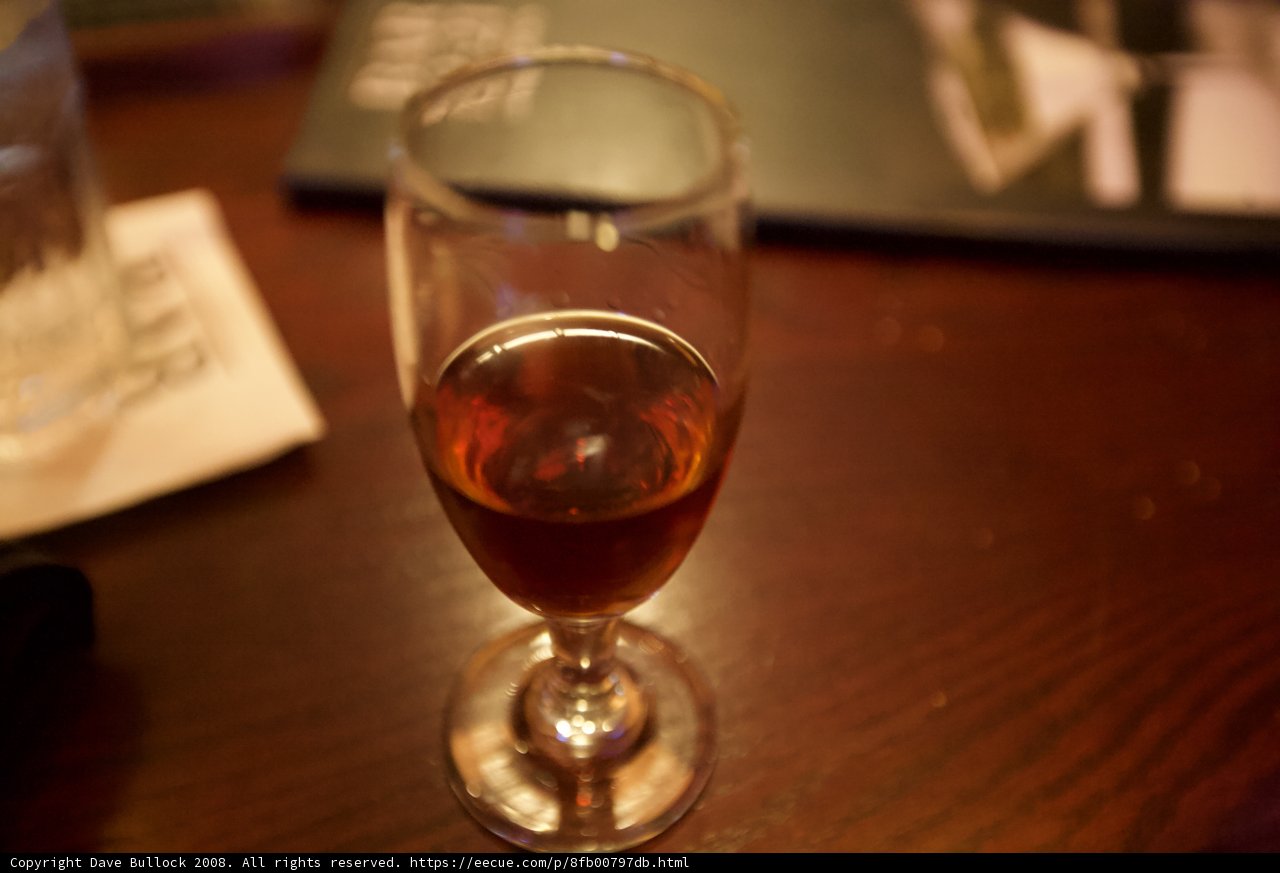 A Glass of Red Wine on Hardwood Table