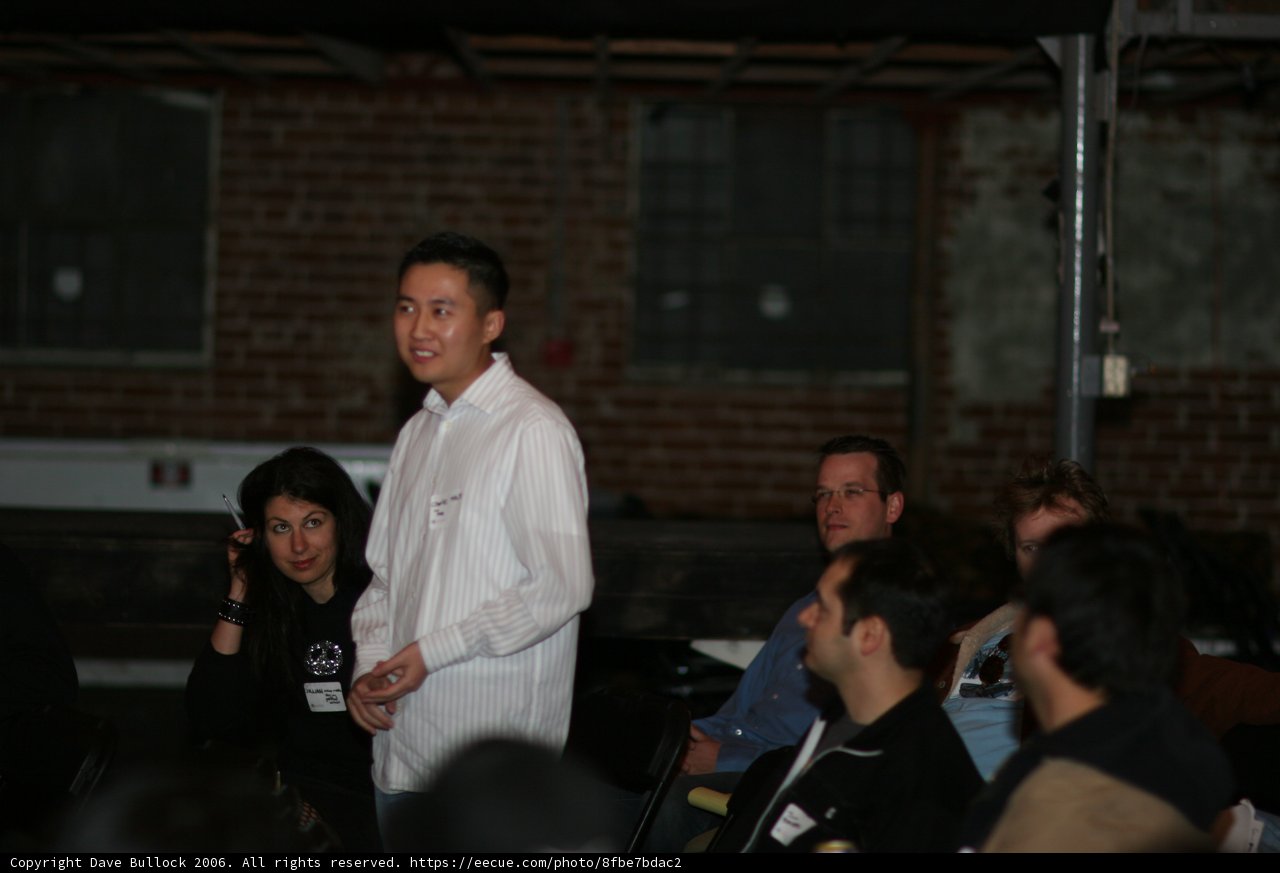 Man in White Standing Before a Crowd