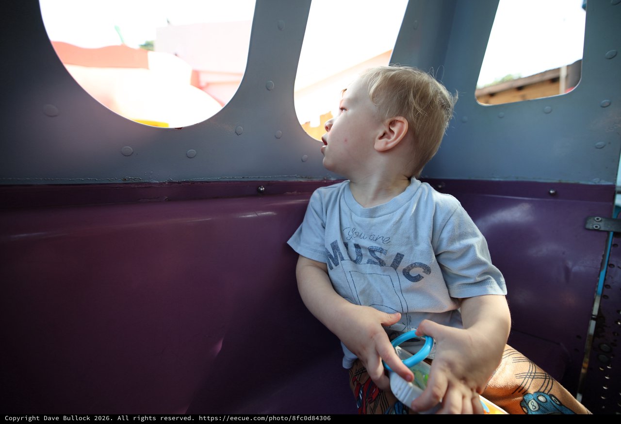 Young Boy Gazing Upward in Playground Structure