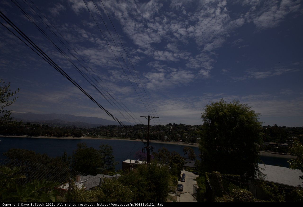 A Scenic View of Power Lines and Sky from the Hillside