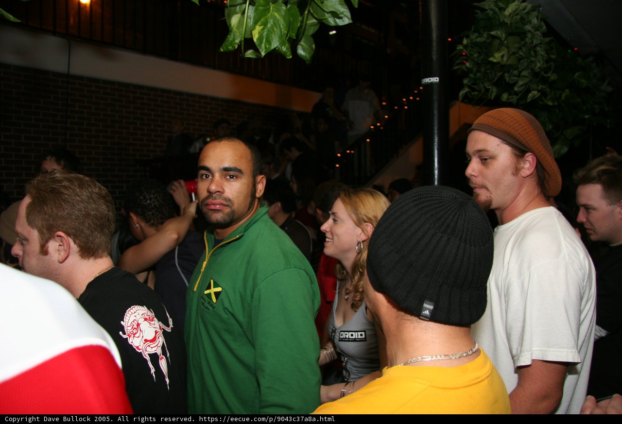 Green Shirted Man at a Vibrant Nightclub