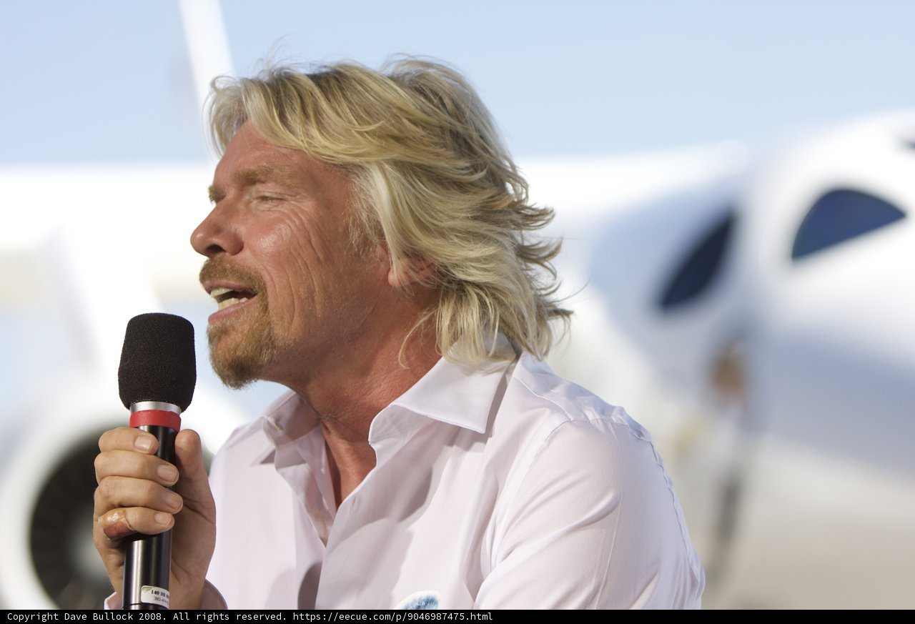 Richard Branson Takes the Stage with Microphone