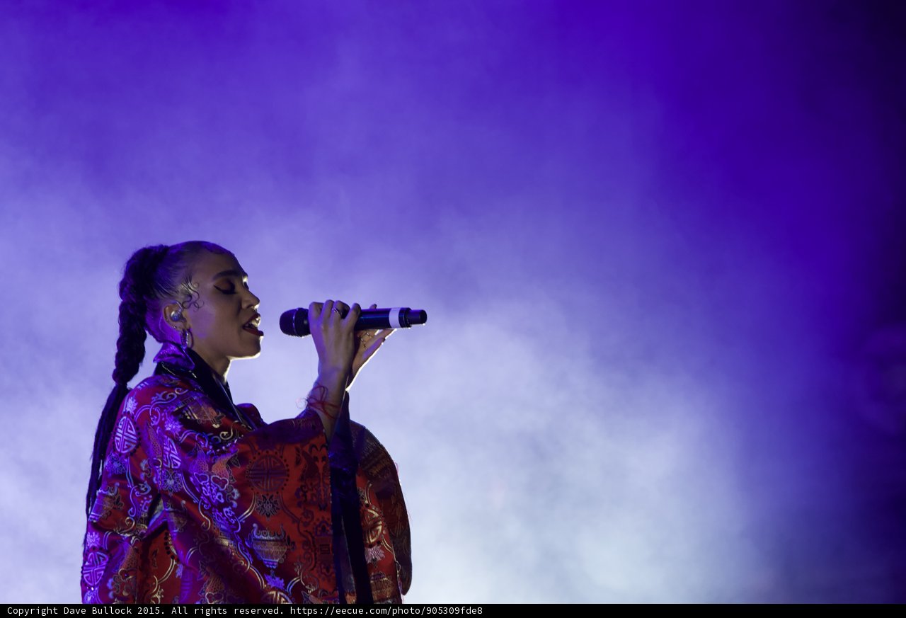 FKA twigs Atmospheric Upper Body Profile Singing Eyes Closed Baby Hairs Swirls Hoop Earrings Braided Ponytail Rings Kimono Red Brocade Gold Purple Patterns Blue Lighting Heavy White Haze