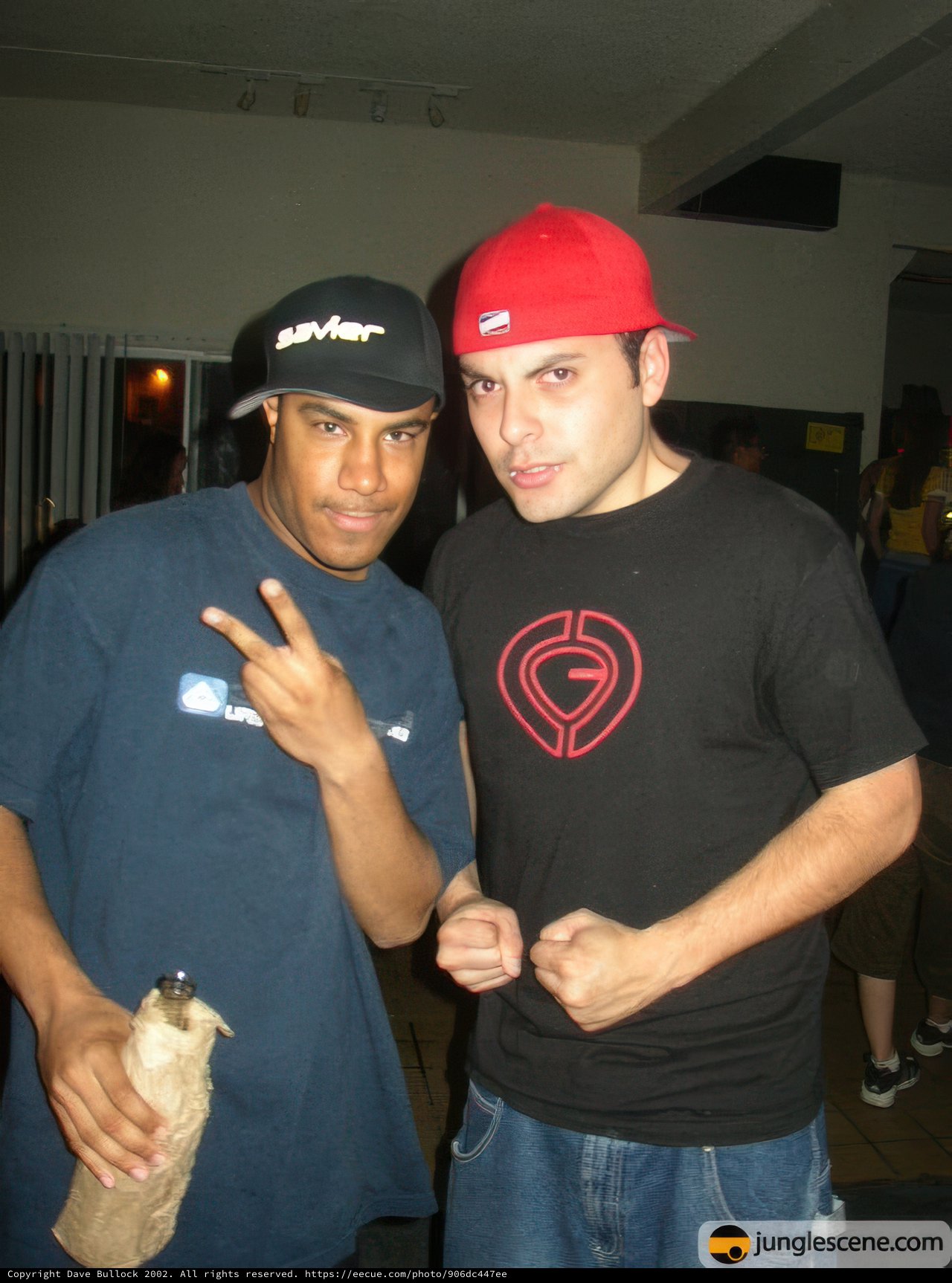 Two Men Strike a Pose in Baseball Caps