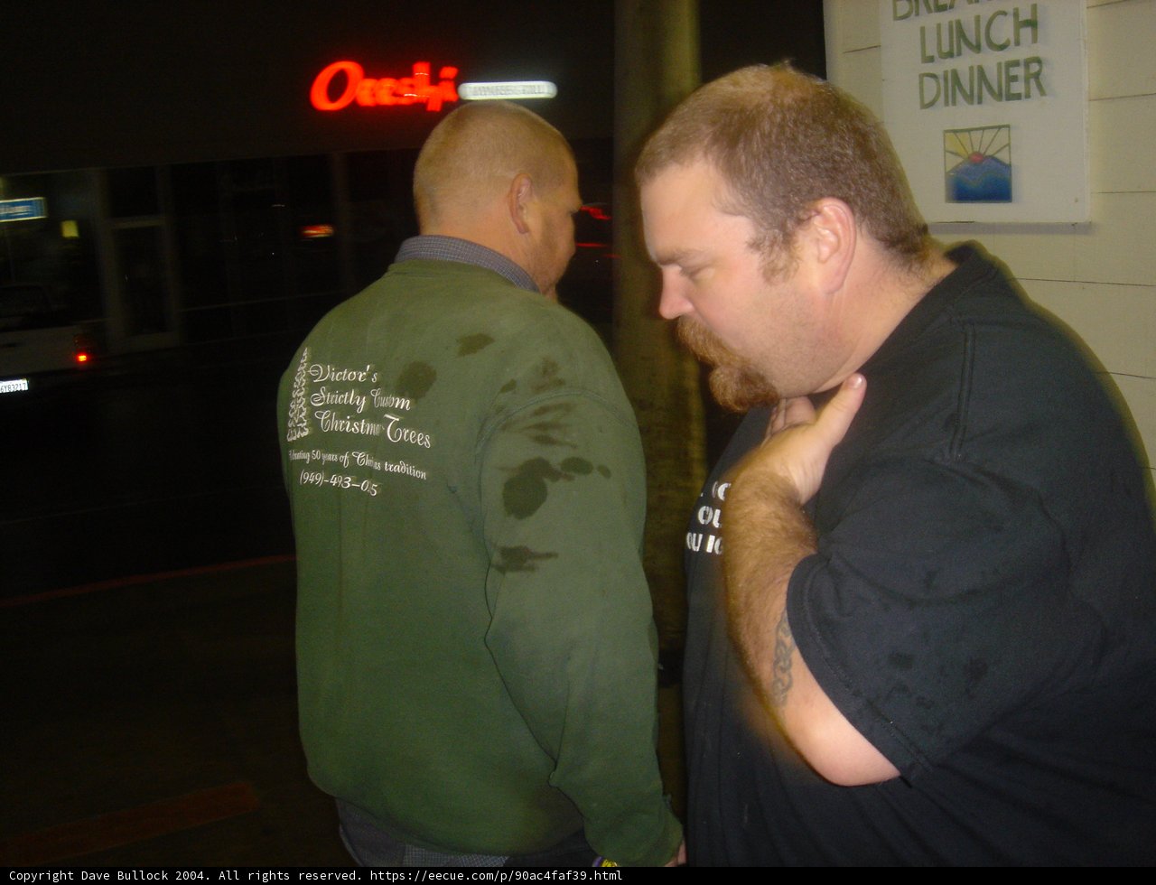 Green-Shirted Man Enjoys Drinks and Games at Urban Pub