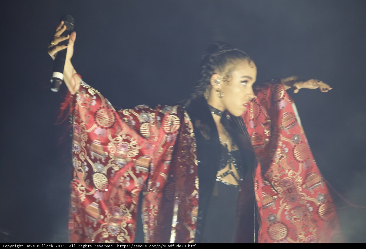FKA twigs Both Arms Extended Red Brocade Kimono Microphone Expressive Hands Profile Dynamic