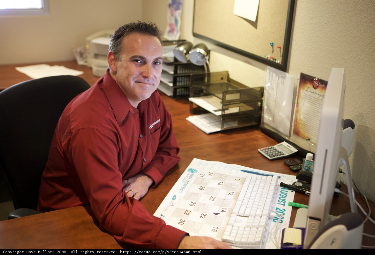 Red-Shirted Man Working on His Computer