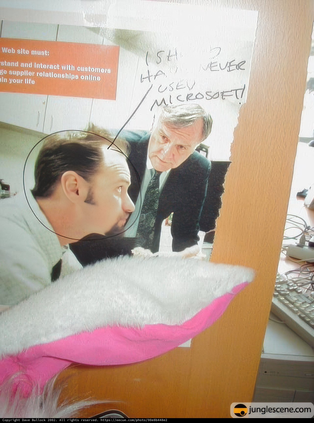 Two Men Admiring White Stuffed Animal