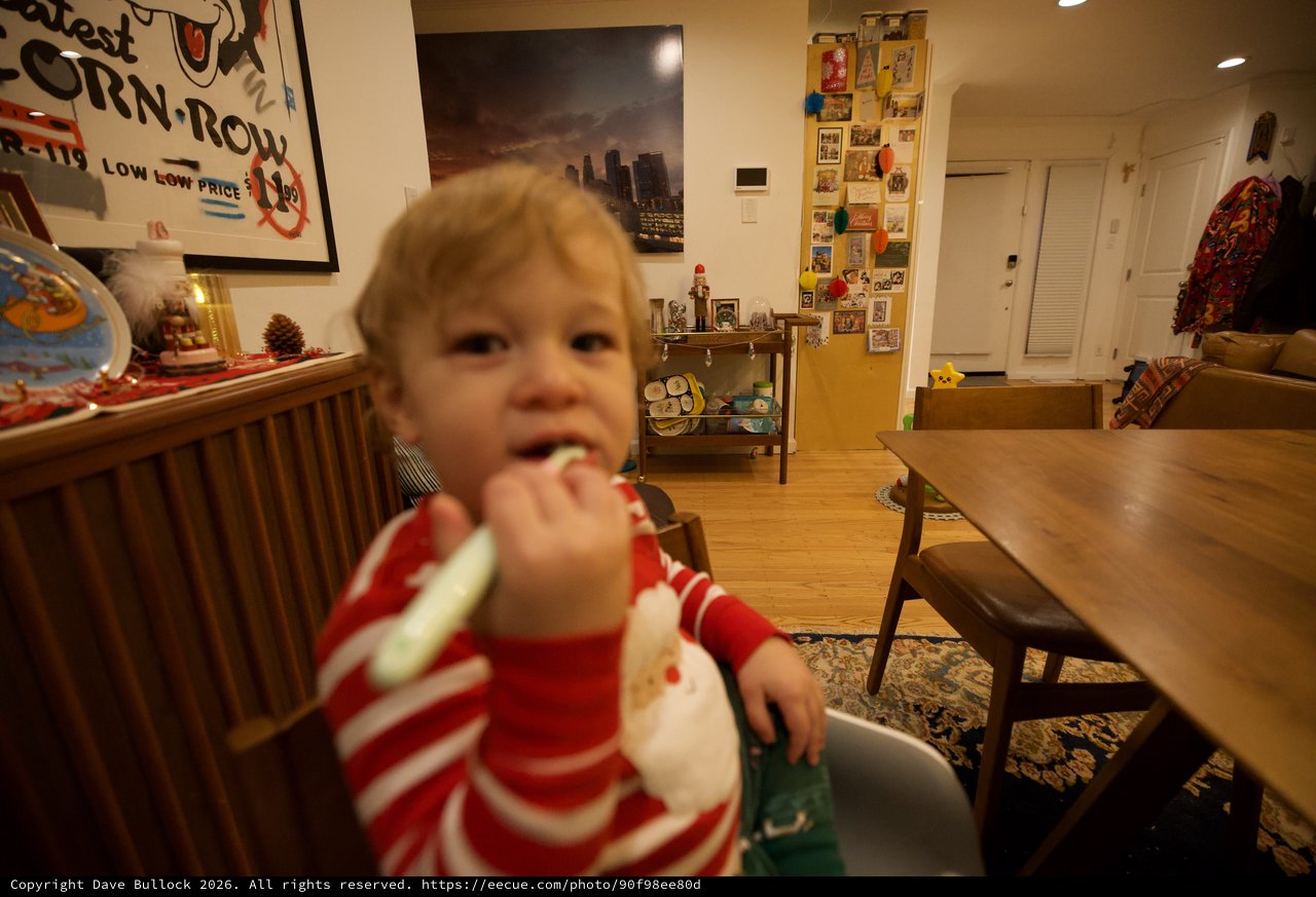 Toddler Eating at Home in Red Striped Pajamas