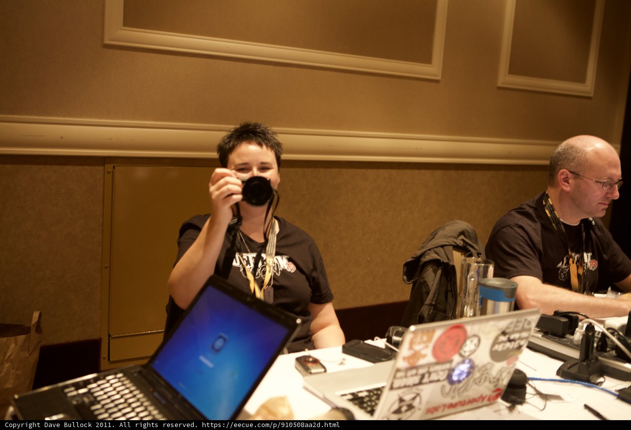 Two Men Working on Laptops with a Camera