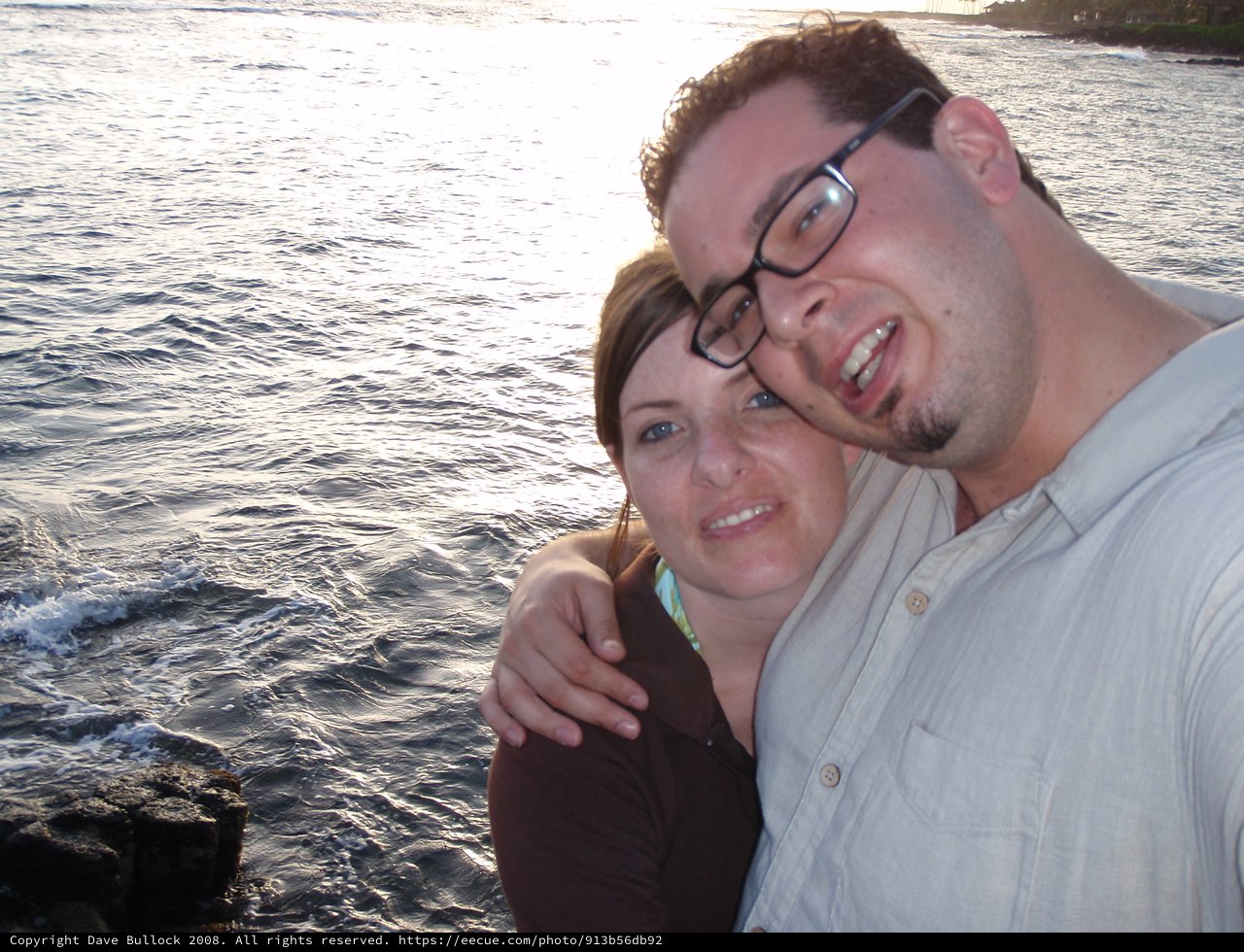 Couple Smiling Together by the Ocean Shore