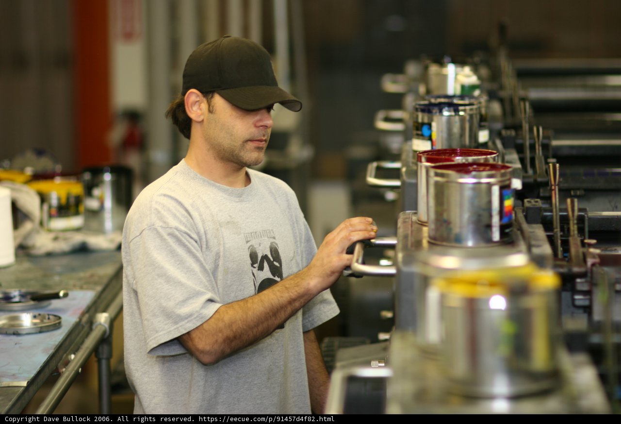 Man in Gray Shirt in a Factory Setting