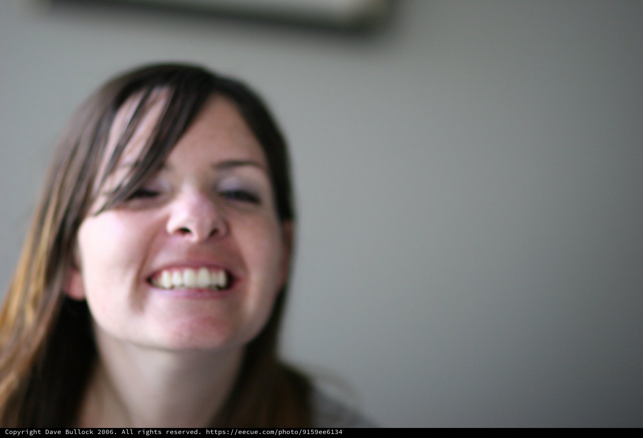Laughing Young Woman with Eyes Closed in Joy
